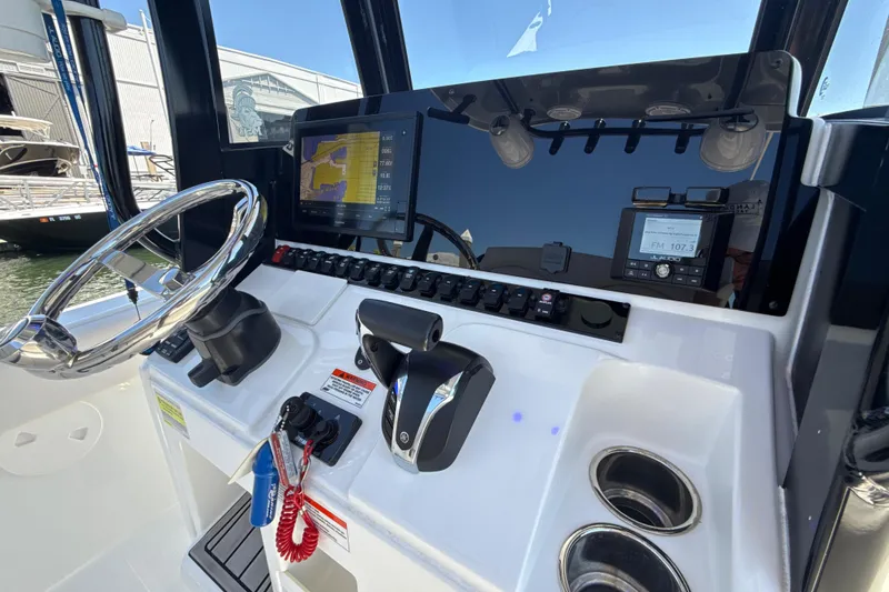 Slide: The Image of 2021 Sea Hunt Ultra 239 SE boat dashboard with steering wheel and navigation controls. - 4