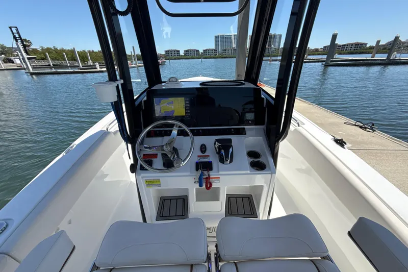 Slide: The Image of 2021 Sea Hunt Ultra 239 SE boat cockpit with steering wheel and navigation system. - 5