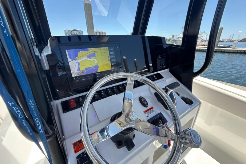 Slide: The Image of 2021 Sea Hunt Ultra 239 SE boat dashboard with navigation display and steering wheel. - 6