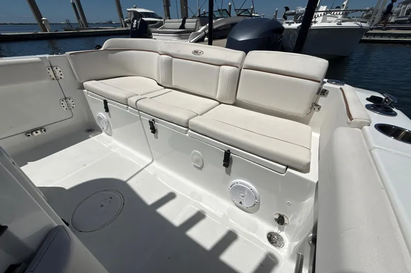 Slide: The Image of 2021 Sea Hunt Ultra 239 SE boat interior with cushioned seating and storage compartments. - 9