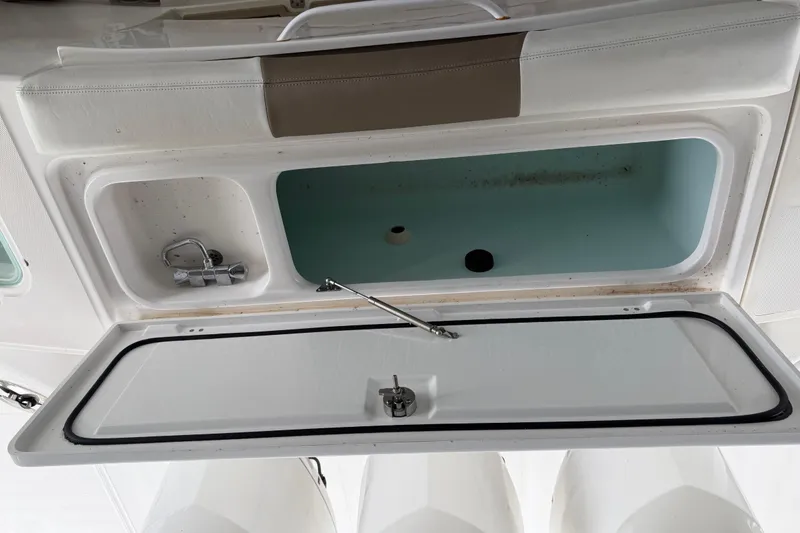 Slide: The Image of Open storage compartment on a 2017 Edgewater 368CC boat, featuring a faucet and sink. - 10