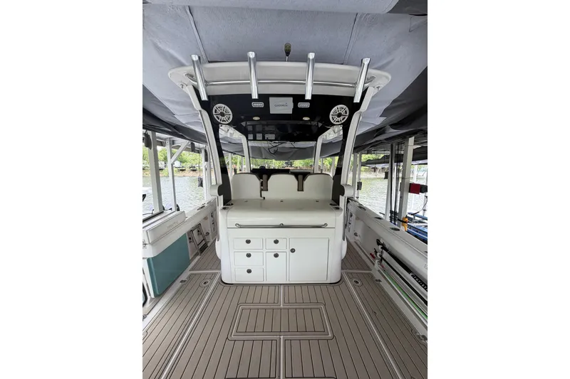 Slide: The Image of 2017 Edgewater 368CC boat interior with seating, storage, and rod holders. - 2