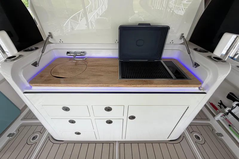 Slide: The Image of 2017 Edgewater 368CC boat kitchen with sink, grill, and storage drawers. - 4