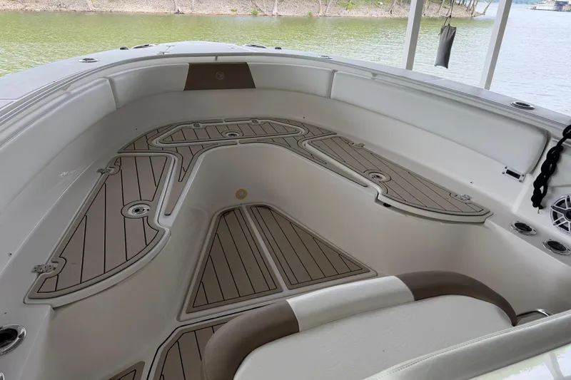 Slide: The Image of Spacious deck of 2017 Edgewater 368CC boat with stylish seating and wood-patterned flooring. - 8