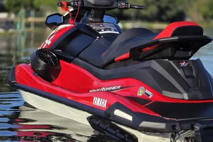 Slide: The Image of 2026 Yamaha WaveRunner VX Cruiser in red on calm water. - 10