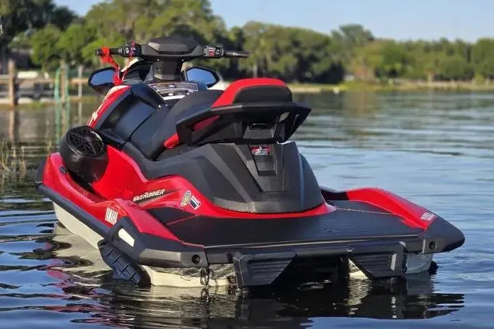 Slide: The Image of 2026 Yamaha WaveRunner VX Cruiser in vibrant red on a serene lake. - 11