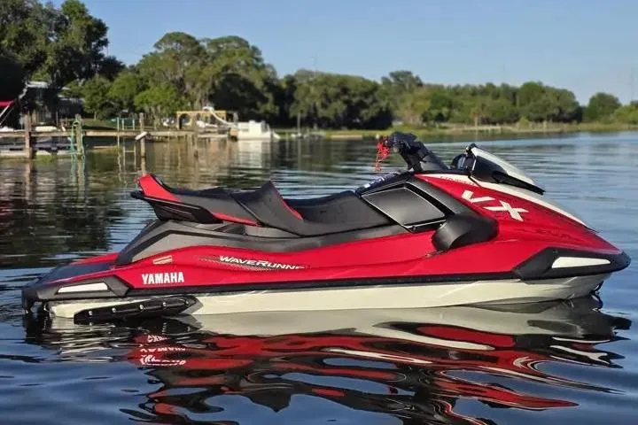 Slide: The Image of 2026 Yamaha WaveRunner VX Cruiser on calm lake water, showcasing sleek red design. - 15