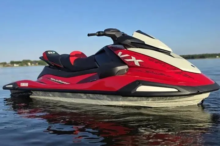 Slide: The Image of 2026 Yamaha WaveRunner VX Cruiser on calm water, showcasing sleek red and white design. - 16