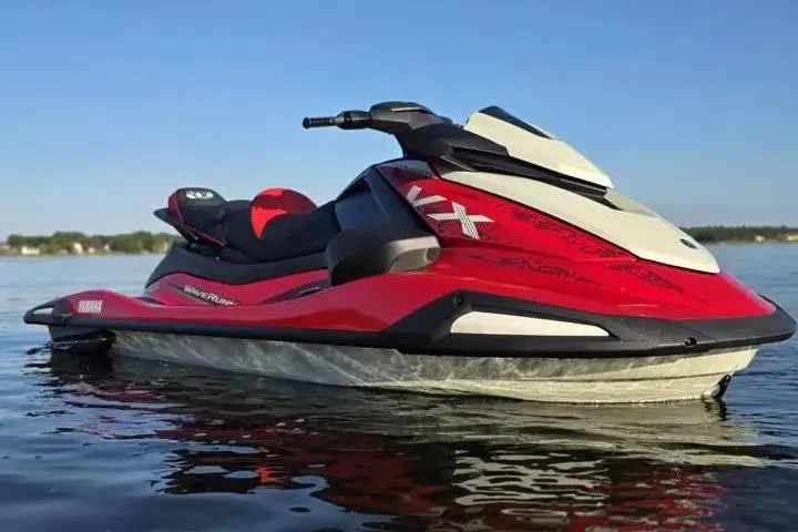 Slide: The Image of 2026 Yamaha WaveRunner VX Cruiser on calm water, showcasing sleek red and white design. - 17