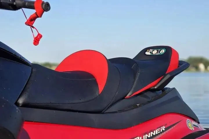 Slide: The Image of 2026 Yamaha WaveRunner VX Cruiser with red and black seat, parked by the water. - 24