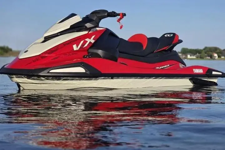 Slide: The Image of 2026 Yamaha WaveRunner VX Cruiser in red and white on calm water. - 4