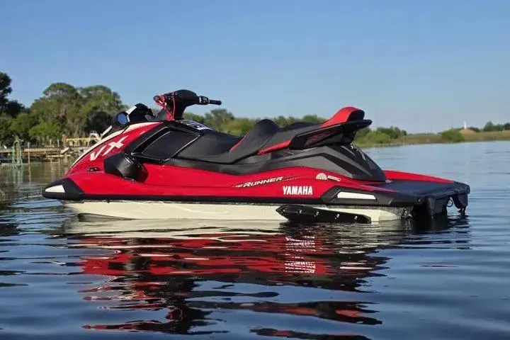 Slide: The Image of 2026 Yamaha WaveRunner VX Cruiser in red, floating on calm water under a clear blue sky. - 8