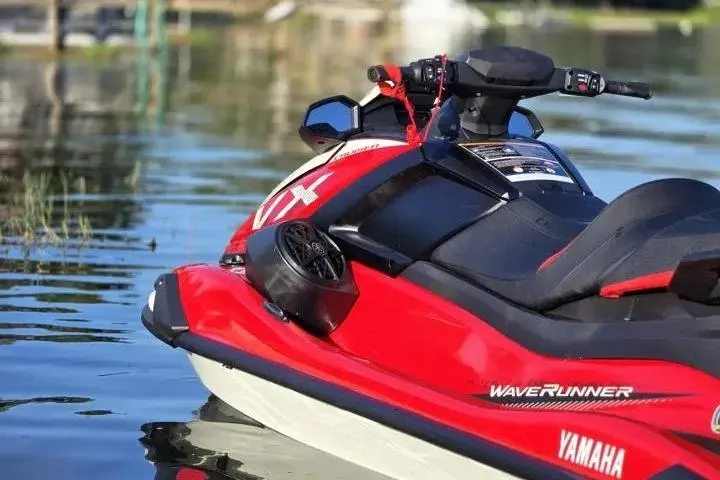 Slide: The Image of 2026 Yamaha WaveRunner VX Cruiser in red, docked on calm water. - 9