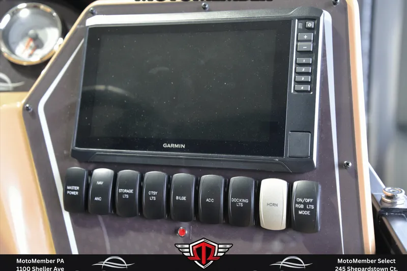 Slide: The Image of Control panel of 2025 SunCatcher Fusion 324SS with Garmin display and various switches. - 16