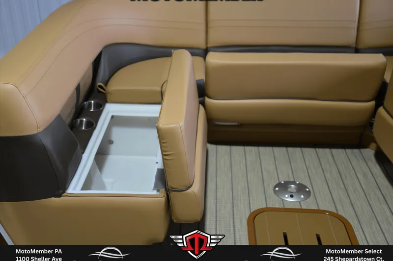 Slide: The Image of 2025 SunCatcher Fusion 324SS boat interior with tan seating and storage compartment. - 24