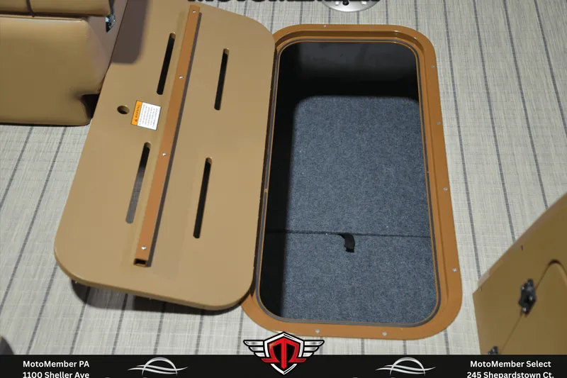 Slide: The Image of Open storage compartment on 2025 SunCatcher Fusion 324SS boat, featuring tan and gray interior. - 20