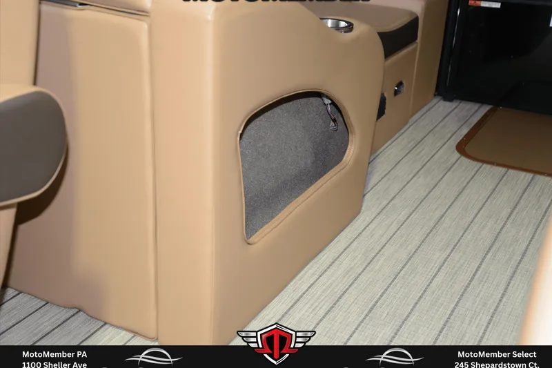 Slide: The Image of Interior of 2025 SunCatcher Fusion 324SS boat, featuring beige seating and striped flooring. - 25