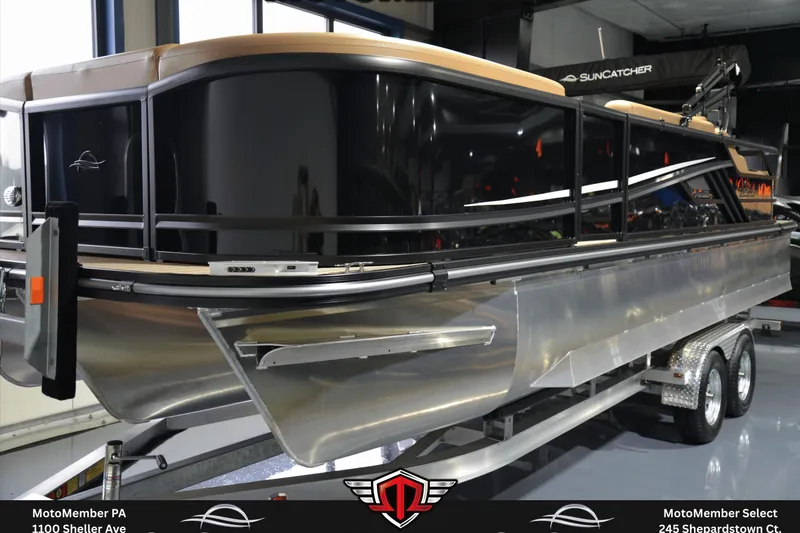 Slide: The Image of 2025 SunCatcher Fusion 324SS pontoon boat on trailer in showroom. - 6