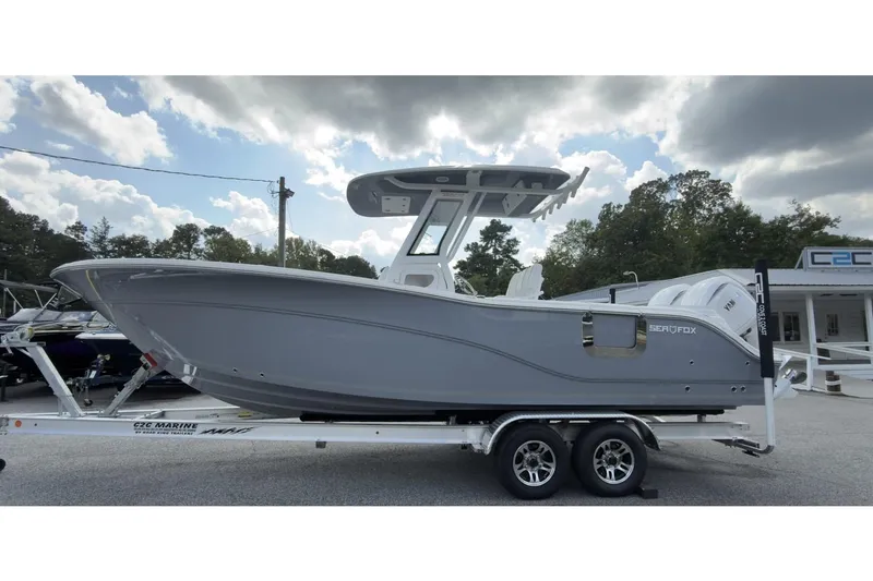 The Image of 2026 Sea Fox 268 Commander boat on trailer, parked outdoors under cloudy sky. - 1