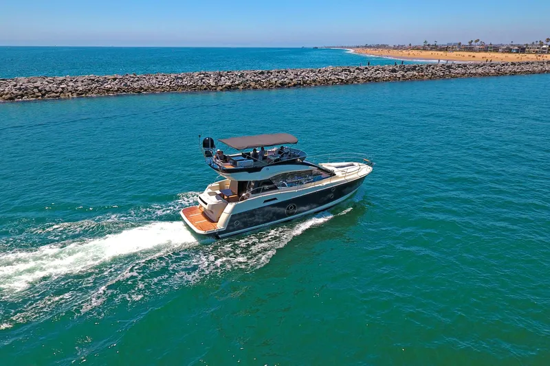 Slide: The Image of 2016 Beneteau Monte Carlo 5 yacht cruising near rocky shoreline. - 12