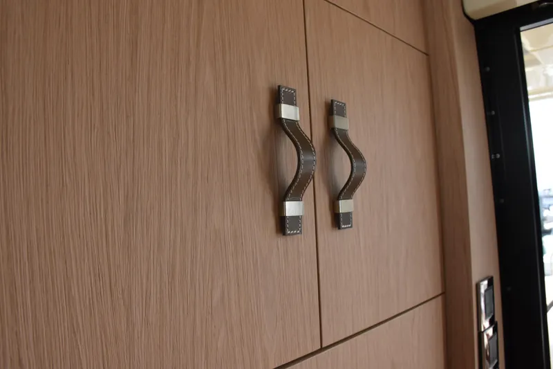 Slide: The Image of Wooden cabinet with leather handles inside a 2016 Beneteau Monte Carlo 5 yacht. - 15