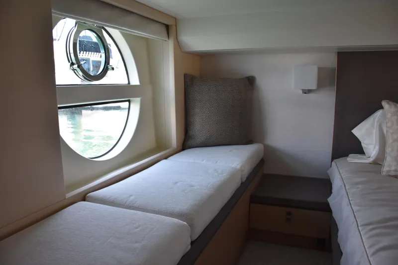 Slide: The Image of Interior of 2016 Beneteau Monte Carlo 5 yacht with cozy seating and porthole window. - 18