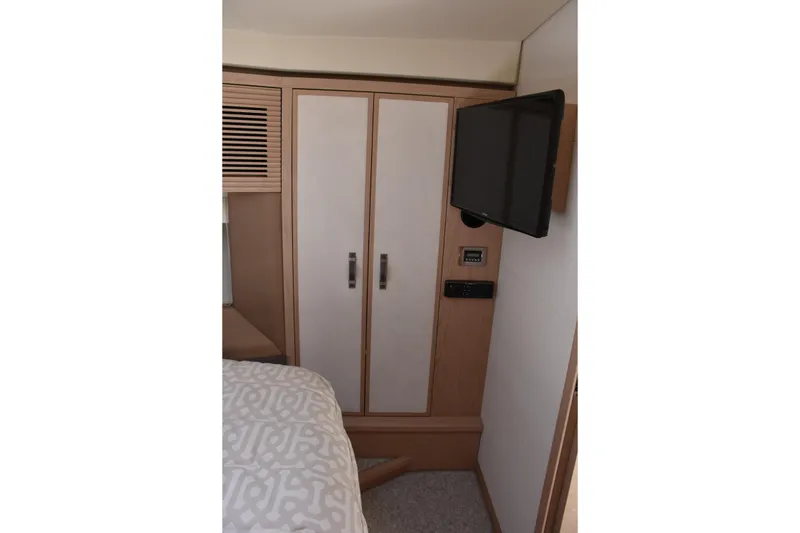 Slide: The Image of Interior of 2016 Beneteau Monte Carlo 5 yacht cabin with TV and wardrobe. - 19