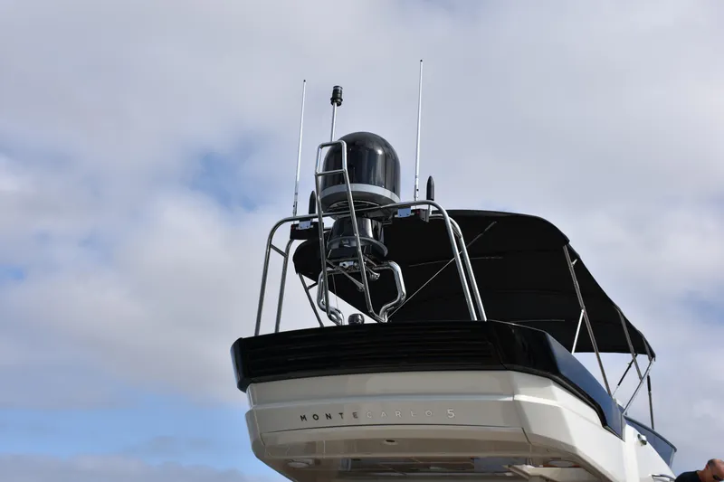 Slide: The Image of 2016 Beneteau Monte Carlo 5 yacht, rear view with radar and antennas against cloudy sky. - 21