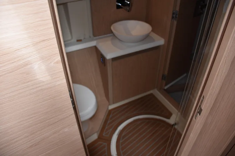 Slide: The Image of Bathroom interior of 2016 Beneteau Monte Carlo 5 yacht, featuring modern sink and toilet. - 23