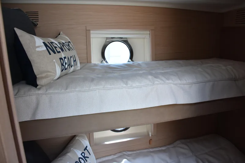 Slide: The Image of Interior of 2016 Beneteau Monte Carlo 5 yacht with cozy bunk beds and nautical decor. - 24