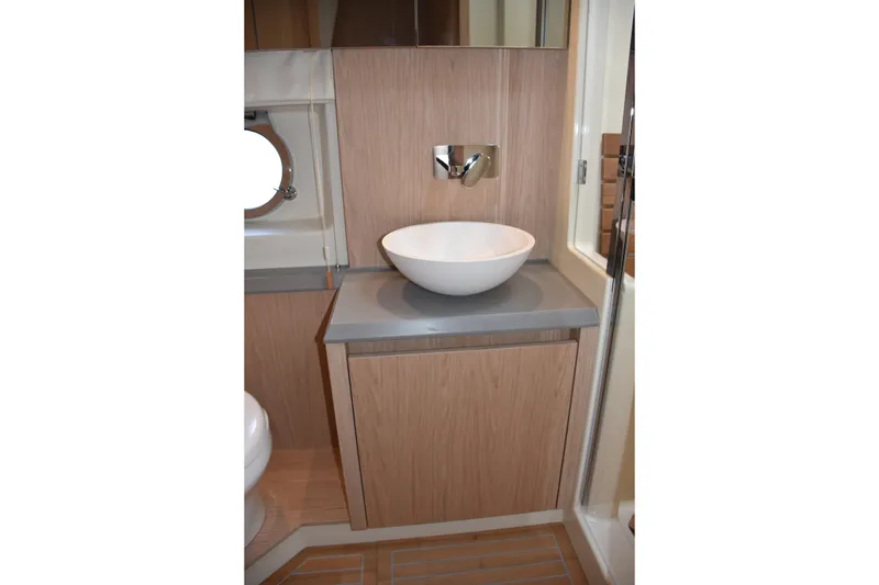 Slide: The Image of Modern bathroom vanity in 2016 Beneteau Monte Carlo 5 yacht, featuring a sleek vessel sink. - 26