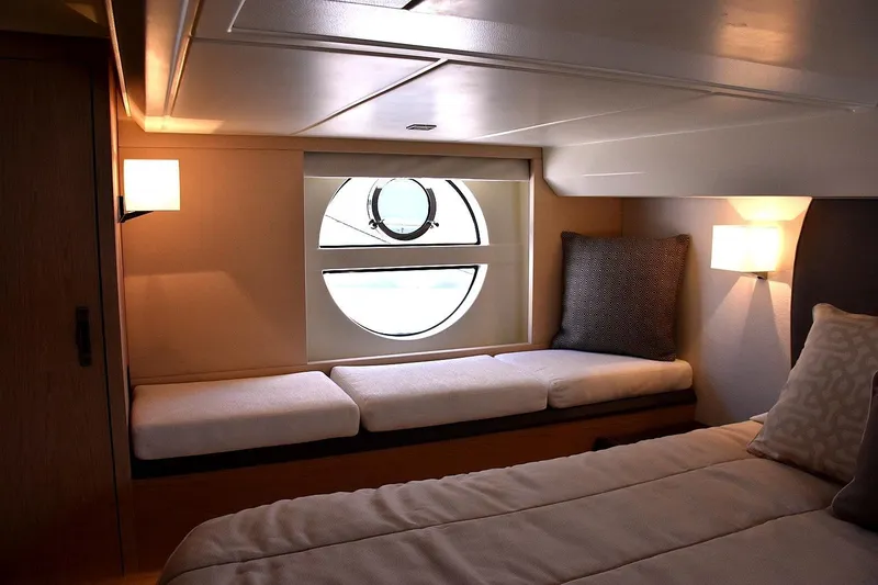 Slide: The Image of Luxurious cabin interior of 2016 Beneteau Monte Carlo 5 yacht with cozy seating and porthole window. - 3