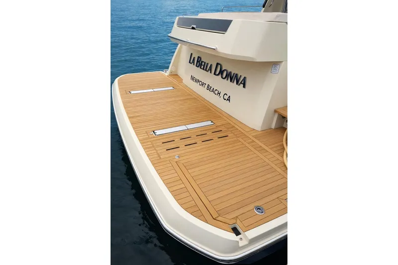 Slide: The Image of 2016 Beneteau Monte Carlo 5 yacht stern with teak deck, named "La Bella Donna." - 32