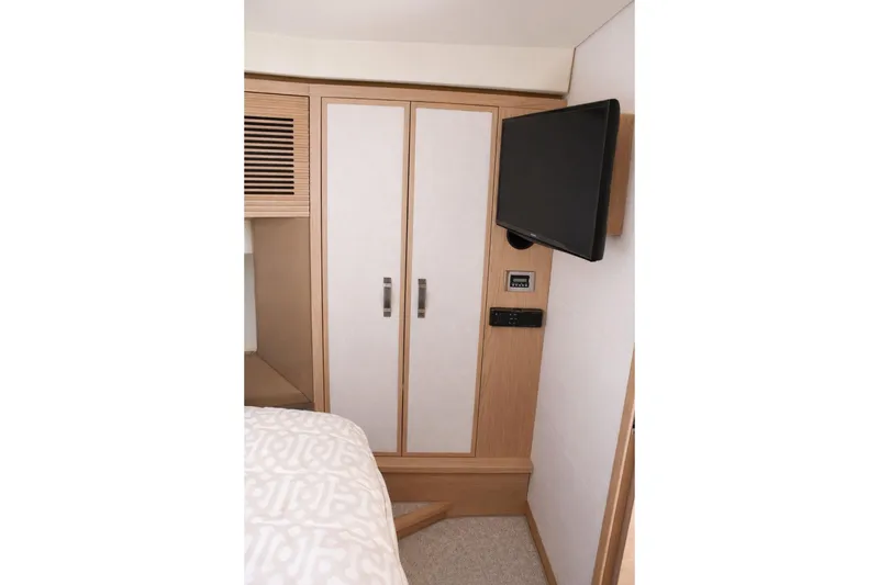 Slide: The Image of Interior of 2016 Beneteau Monte Carlo 5 yacht with TV and wardrobe. - 34