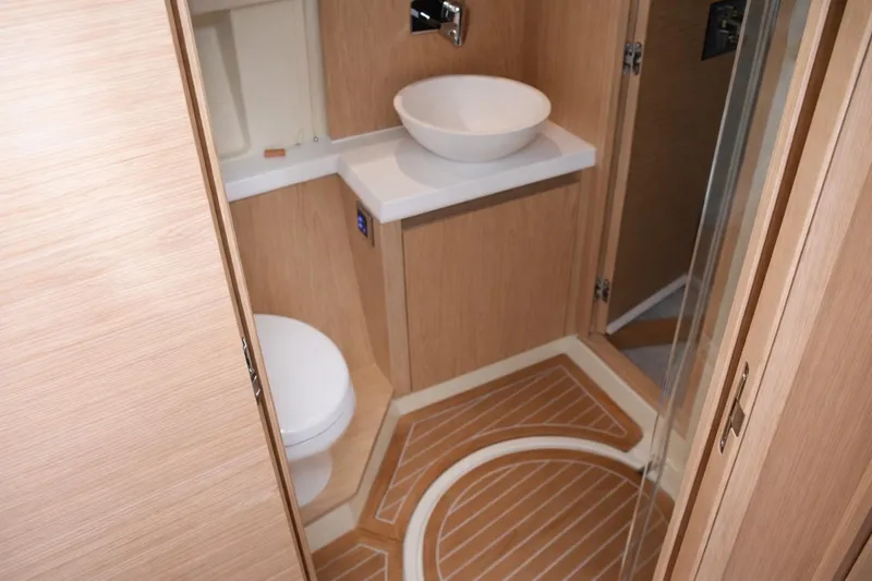 Slide: The Image of Luxurious bathroom in 2016 Beneteau Monte Carlo 5 yacht, featuring modern fixtures and wood accents. - 37