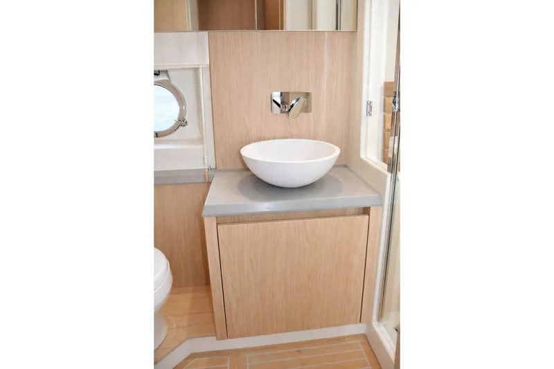 Slide: The Image of Modern bathroom vanity on 2016 Beneteau Monte Carlo 5 yacht, featuring sleek vessel sink. - 38