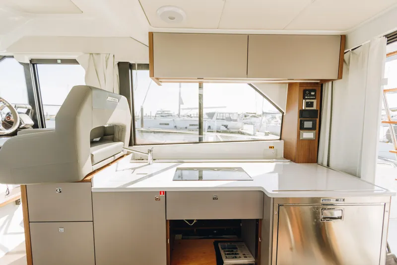 Slide: The Image of Modern kitchen interior of 2026 Beneteau Antares 12 Fly yacht with sleek design. - 12