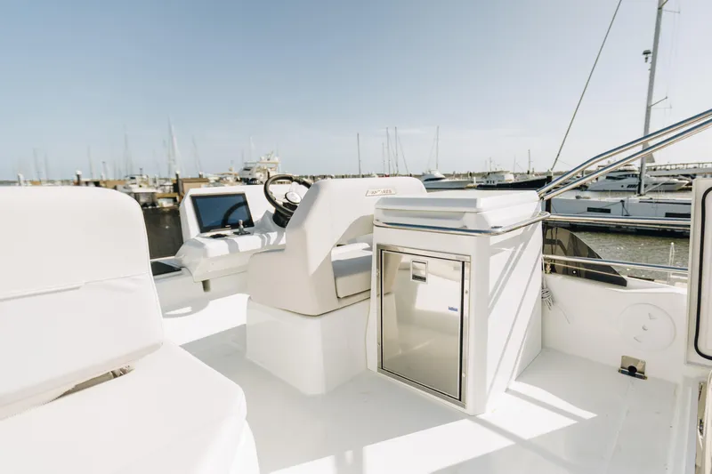 Slide: The Image of Flybridge of 2026 Beneteau Antares 12 Fly yacht, featuring helm and seating area. - 4