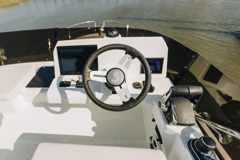 Slide: The Image of Steering console of 2026 Beneteau Antares 12 Fly yacht with modern controls. - 5
