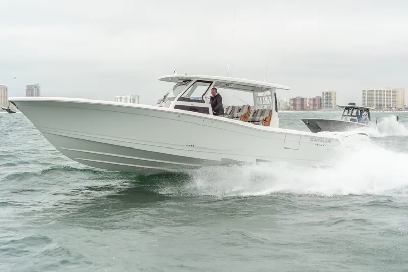 The Image of Caymas 401 DR 2027 boat cruising on water with city skyline. - 0
