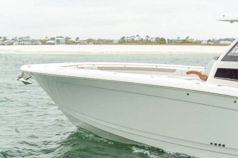 Slide: The Image of Caymas 401 DR 2027 boat on calm water near coastline. - 13
