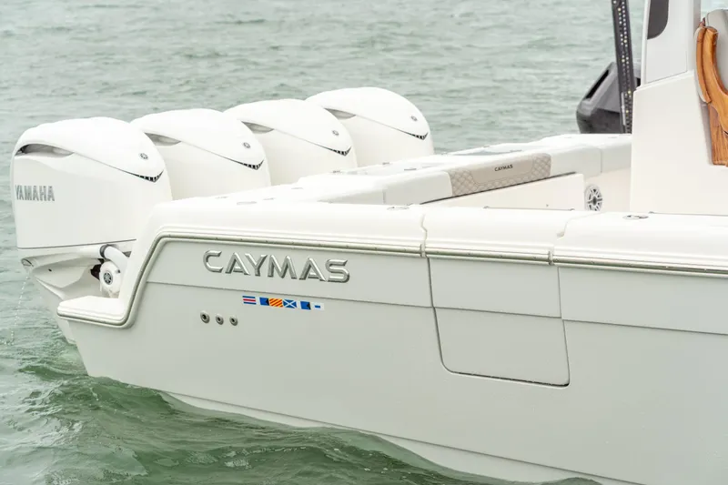 Slide: The Image of Caymas 401 DR 2027 boat with Yamaha engines on water. - 14