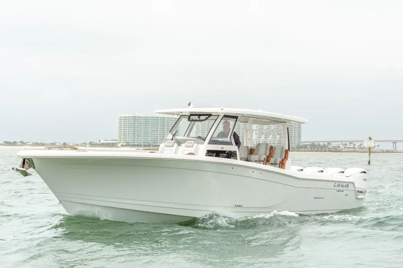 Slide: The Image of Caymas 401 DR 2027 boat cruising on water with coastal backdrop. - 2