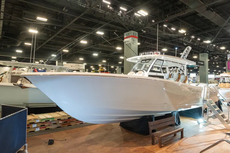 Slide: The Image of 2027 Caymas 401 DR boat displayed at a trade show. - 4
