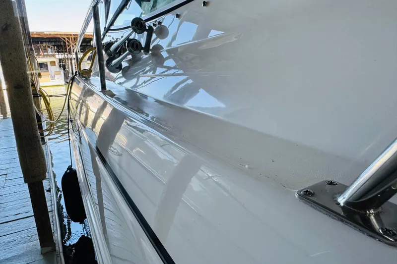 Slide: The Image of Side view of a 2000 Cruisers Yachts 3575 Express docked at a marina. - 10