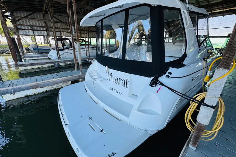 Slide: The Image of 2000 Cruisers Yachts 3575 Express docked in a marina, rear view. - 11