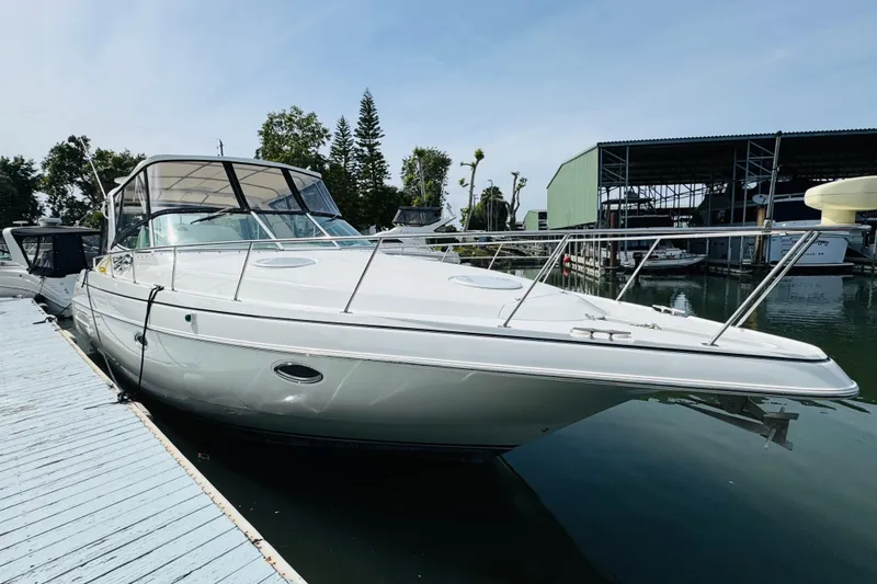 Slide: The Image of 2000 Cruisers Yachts 3575 Express docked at marina, clear sky background. - 14