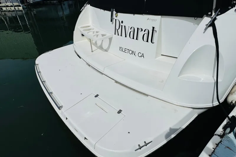 Slide: The Image of 2000 Cruisers Yachts 3575 Express docked, rear view with swim platform. - 16