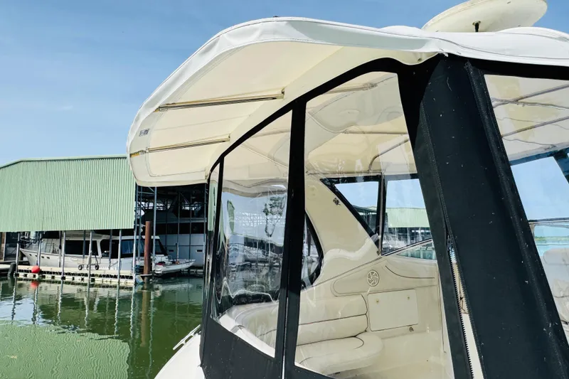 Slide: The Image of 2000 Cruisers Yachts 3575 Express at marina, featuring sleek design and clear canopy. - 17