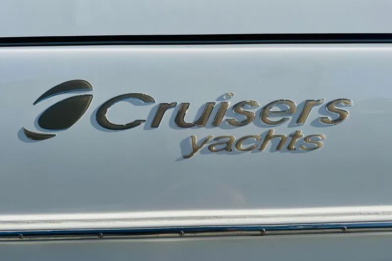 Slide: The Image of Cruisers Yachts logo on 2000 3575 Express boat exterior. - 19